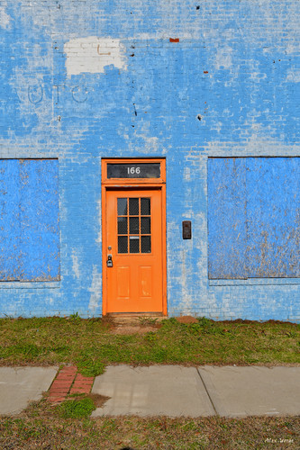 Orange Door of Shuttered Building